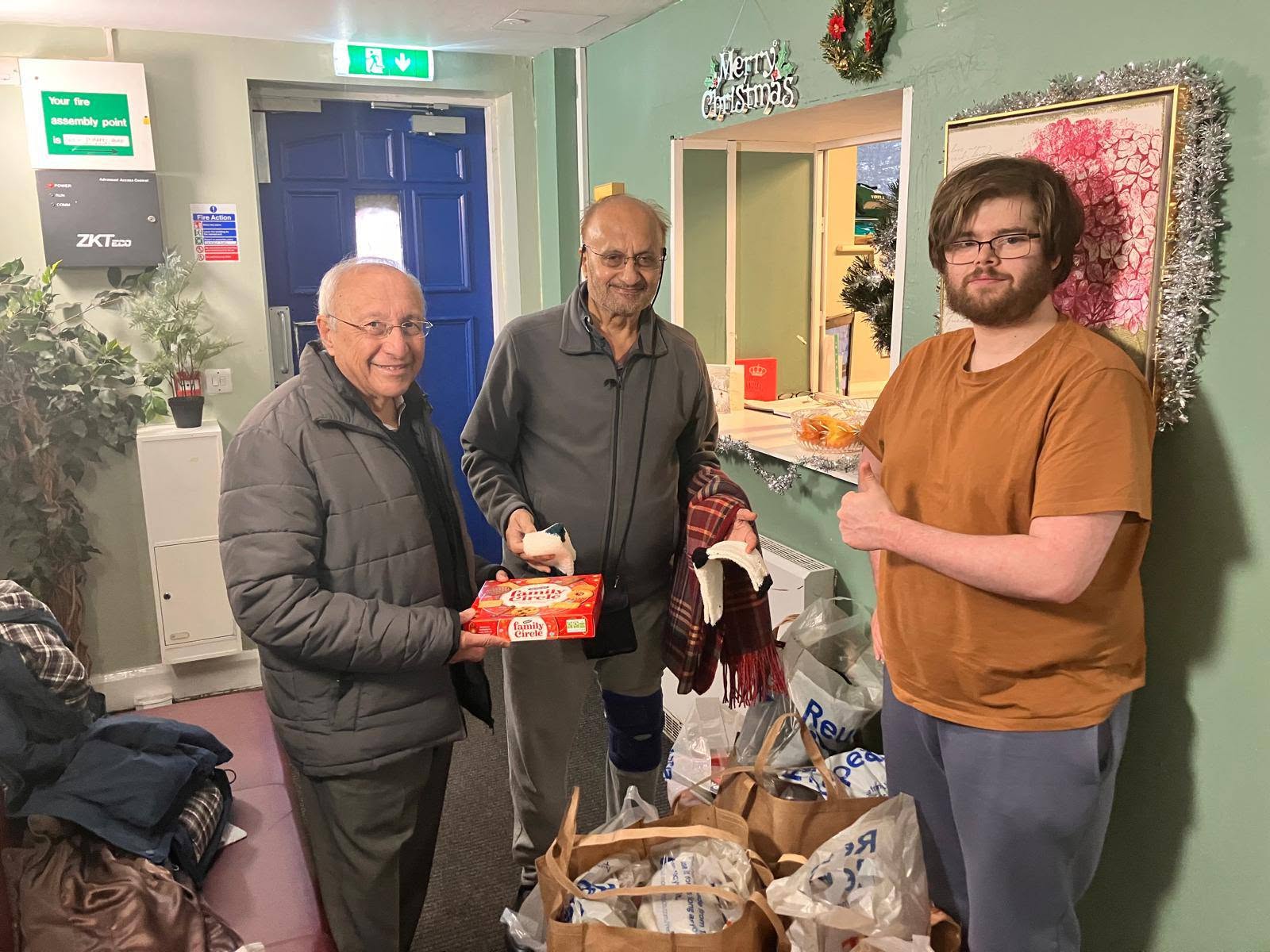 Lions volunteers serving Christmas dinner in a community hall